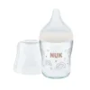 Biberon de sticla 120 ml cu tetina din silicon si control de temperatura Nuk PM Strenght 0 luni + S Rainbow