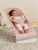 Balansoar Bliss BabyBjorn Dusty Pink cu aspect delicat de petala tesatura matlasata cu bara de jucarii inclusa