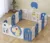 Gardulet loc de joaca pentru copii Nichiduta Garden Blue Dinosaur pliabil si portabil, de interiorexterior, compus din 14 panouri de gard + 2 panouri laterale, inalt 61cm, Cos de baschet si angrenaje rotative