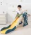 Tobogan pentru copii Nichiduta Garden Dinosaur Green, de interiorexterior cu mini-cos de Baschet si joc de precizie cu inele, prevazut cu scara, manere de sustinere, design pliabil, dimensiune 150 x 67.5 cm